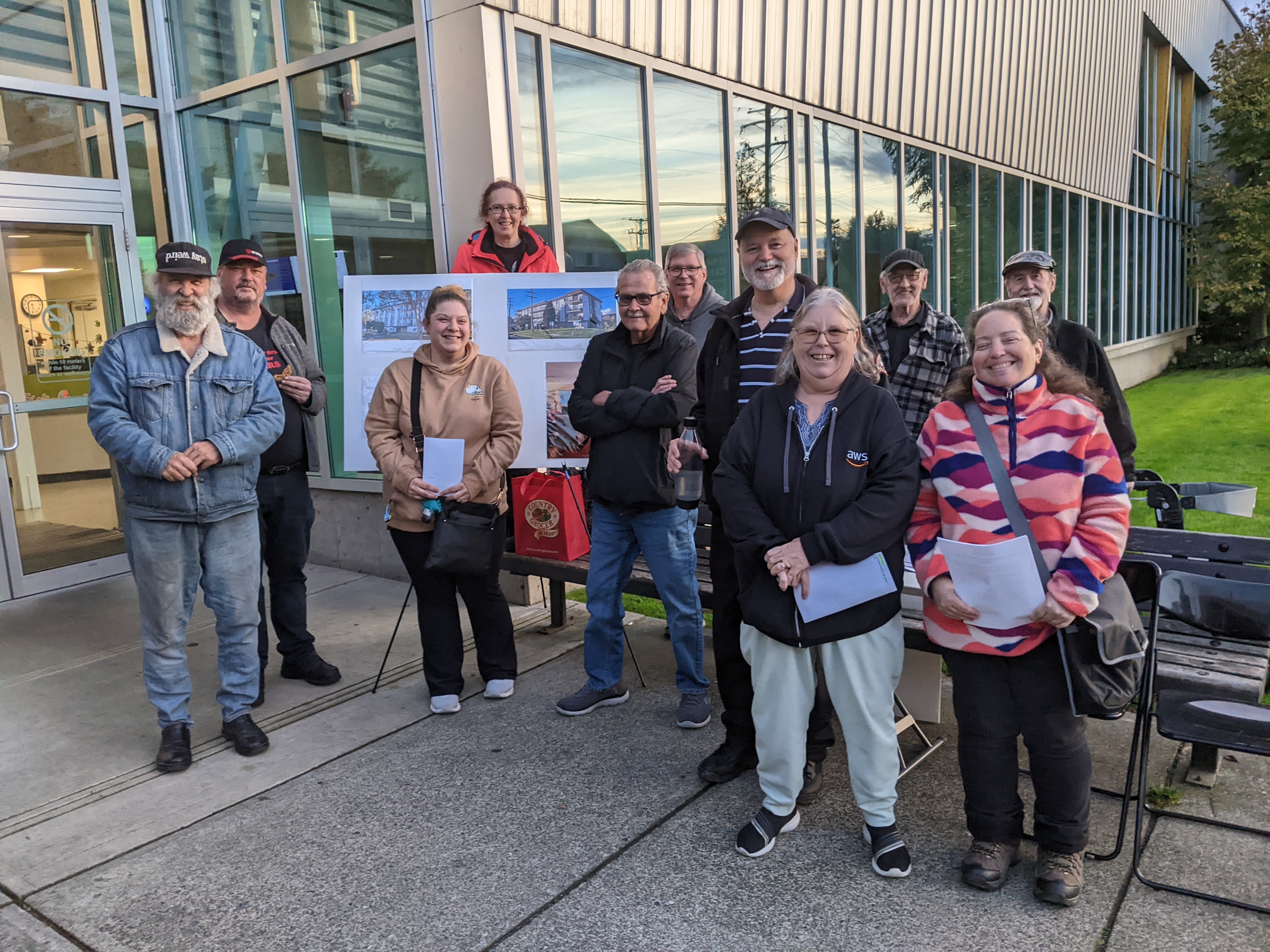 NTA members posing in front of an info board